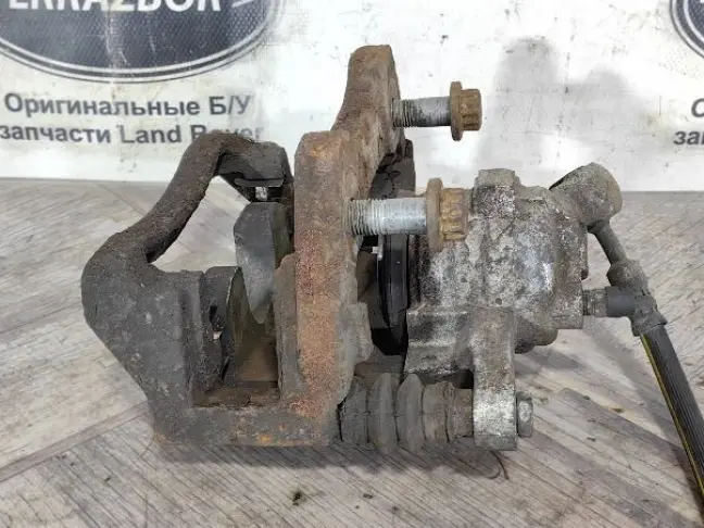 Суппорт тормозной задний левый DISCOVERY 3 L319