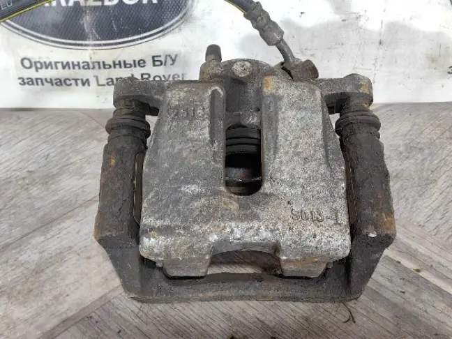 Суппорт тормозной задний левый DISCOVERY 3 L319