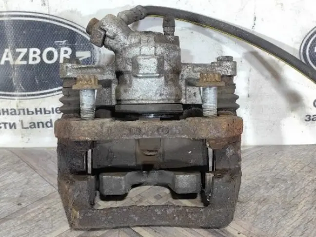 Суппорт тормозной задний левый DISCOVERY 3 L319