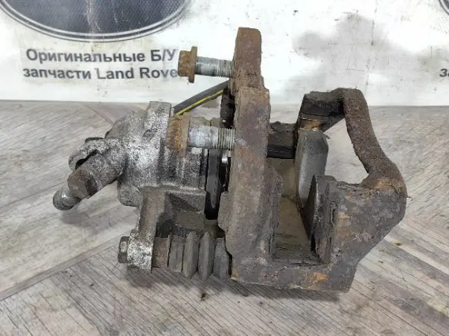 Суппорт тормозной задний левый DISCOVERY 3 L319