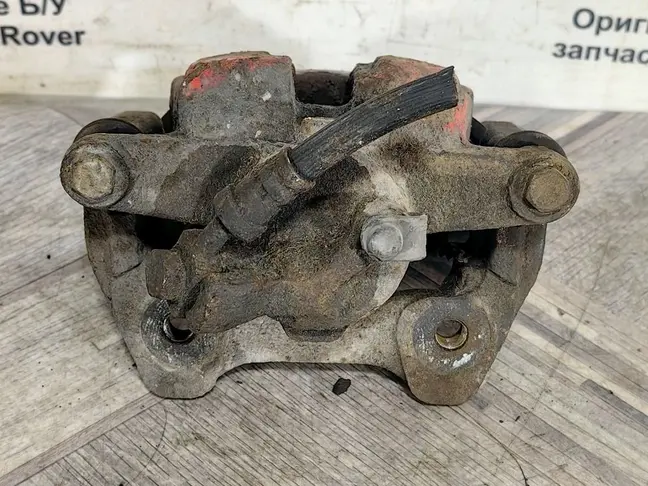 Суппорт тормозной задний левый DISCOVERY 3 L319