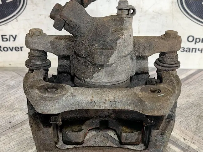 Суппорт тормозной задний левый DISCOVERY 3 L319